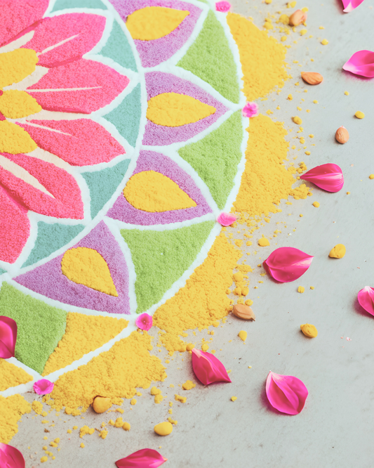 Colourful rangoli with decorative petals beside it