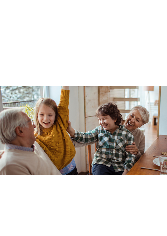Two children laughing with their grandparents