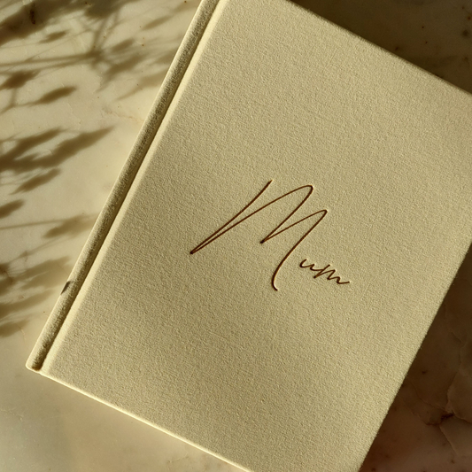 Ivory linen journal with 'Mum' written in gold on the cover