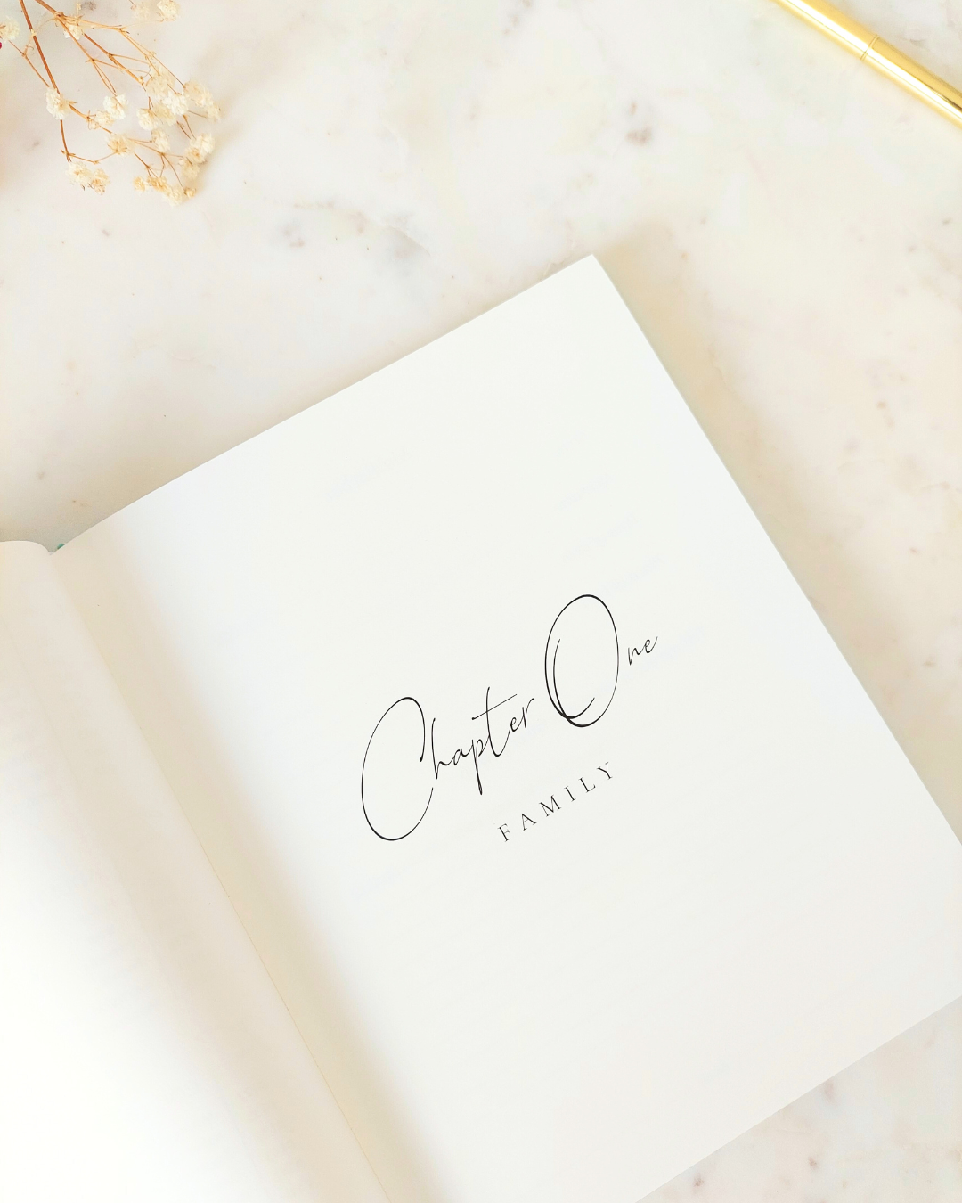 Open book with 'Chapter One Family' on a marble surface